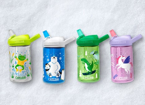 Snowy background with custom kids' bottles lined up on the ground