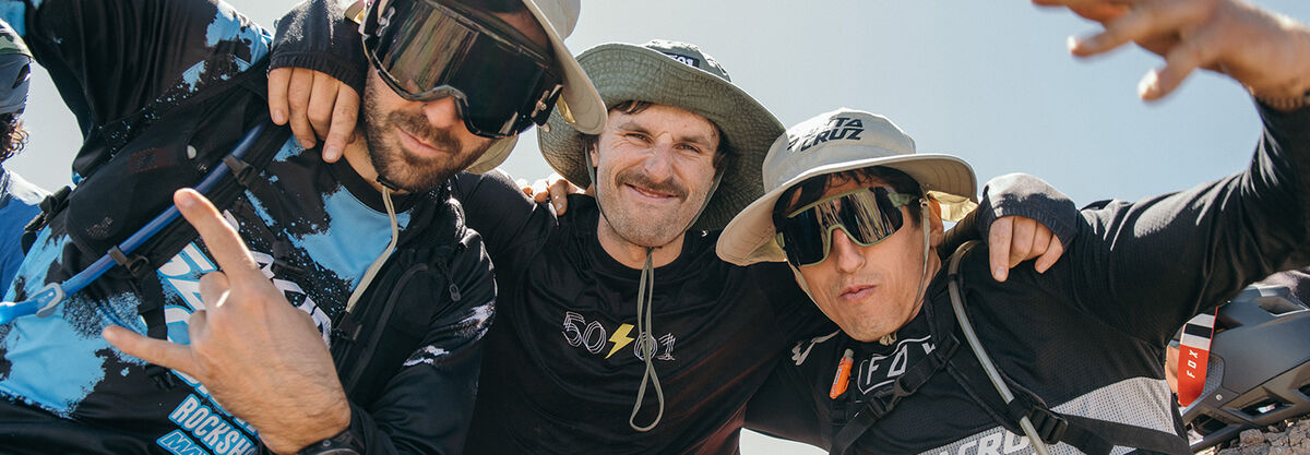 Three men wearing hats in the sunshine.