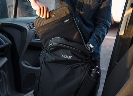 A person putting their included laptop case inside of the ATP.