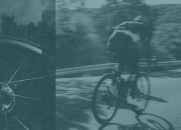 blurred biker on the road with wheel close up