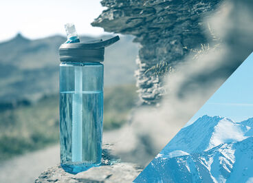 True Blue Eddy+ bottle sitting on a rocky ledge.