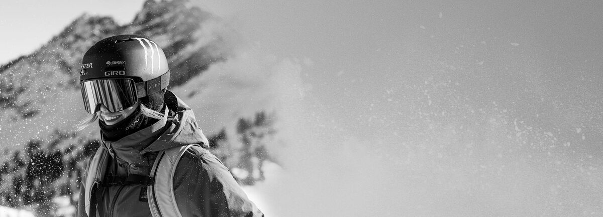 Brita Sigourney smiling with ski gear on and snow blowing around her.