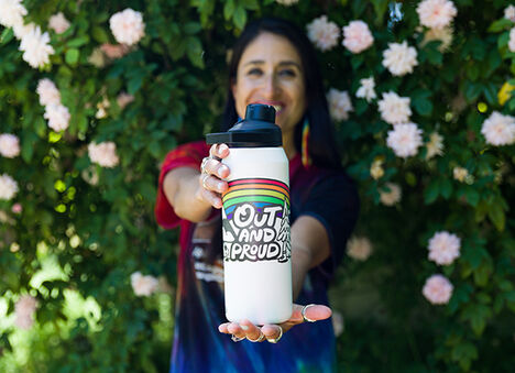Renee Ho from APT holding a Limited Edition Pride Chute Mag bottle