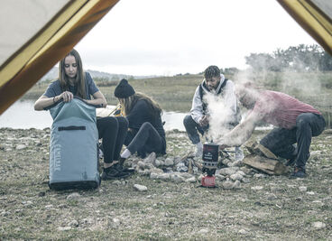 Campers sitting around a fire.