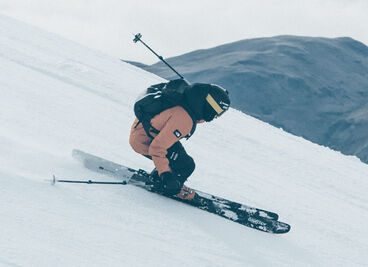 Skier going down a snowy mountain