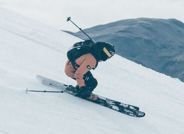 Skier going down a snowy mountain