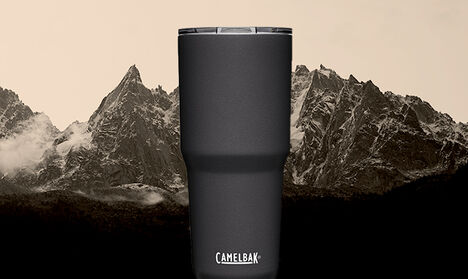 A Horizon Tumbler sitting in front of a snowy mountain landscape