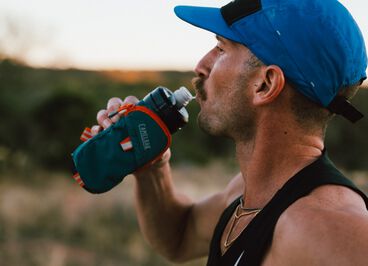 man drinking out of a quick grip water bottle