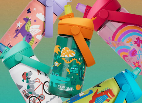 Kids bottles over a green background
