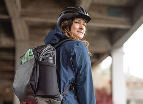 Woman looking back while wearing a MULE Commute Pack Woman looking back while wearing a MULE Commute Pack