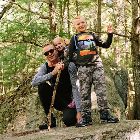 A father with his two children after a hike A father with his two children after a hike