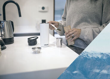 Person using their tea strainer accessory in a forge flow bottle.