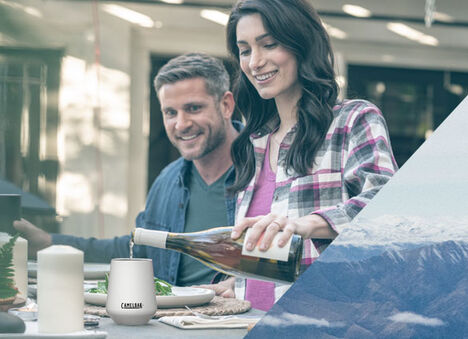 Woman pouring wine into a white wine tumbler. Woman pouring wine into a white wine tumbler.