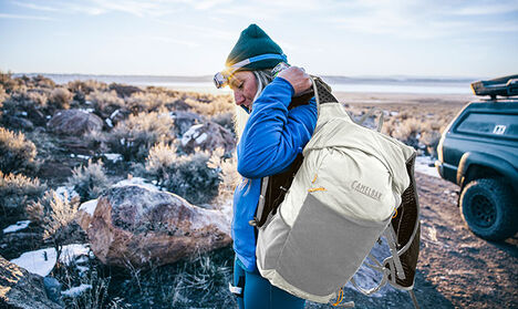 Woman gearing up with a new Octane 16 Hydration pack Woman gearing up with a new Octane 16 Hydration pack