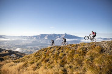 Image of three bike riders on a mountain trail.