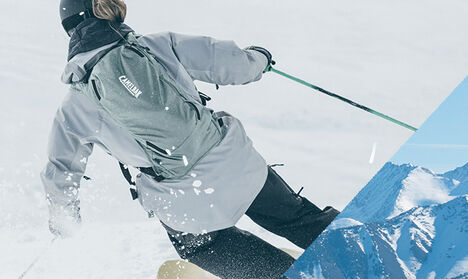 Skier Wearing the Zoid Snow Hydration Pack down the Mountain Skier Wearing the Zoid Snow Hydration Pack down the Mountain