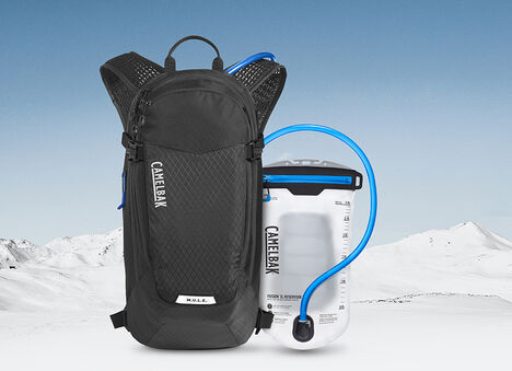 Snowy Background with Black CamelBak Pack and Reservoir