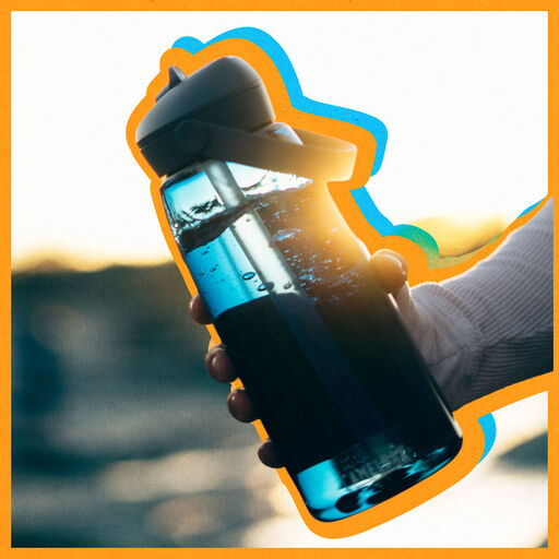 person holding a blue bottle with an orange offset treatment