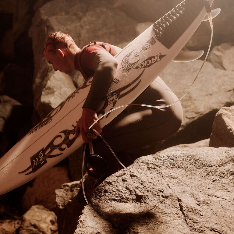 Cole Houshmand holding surfboard