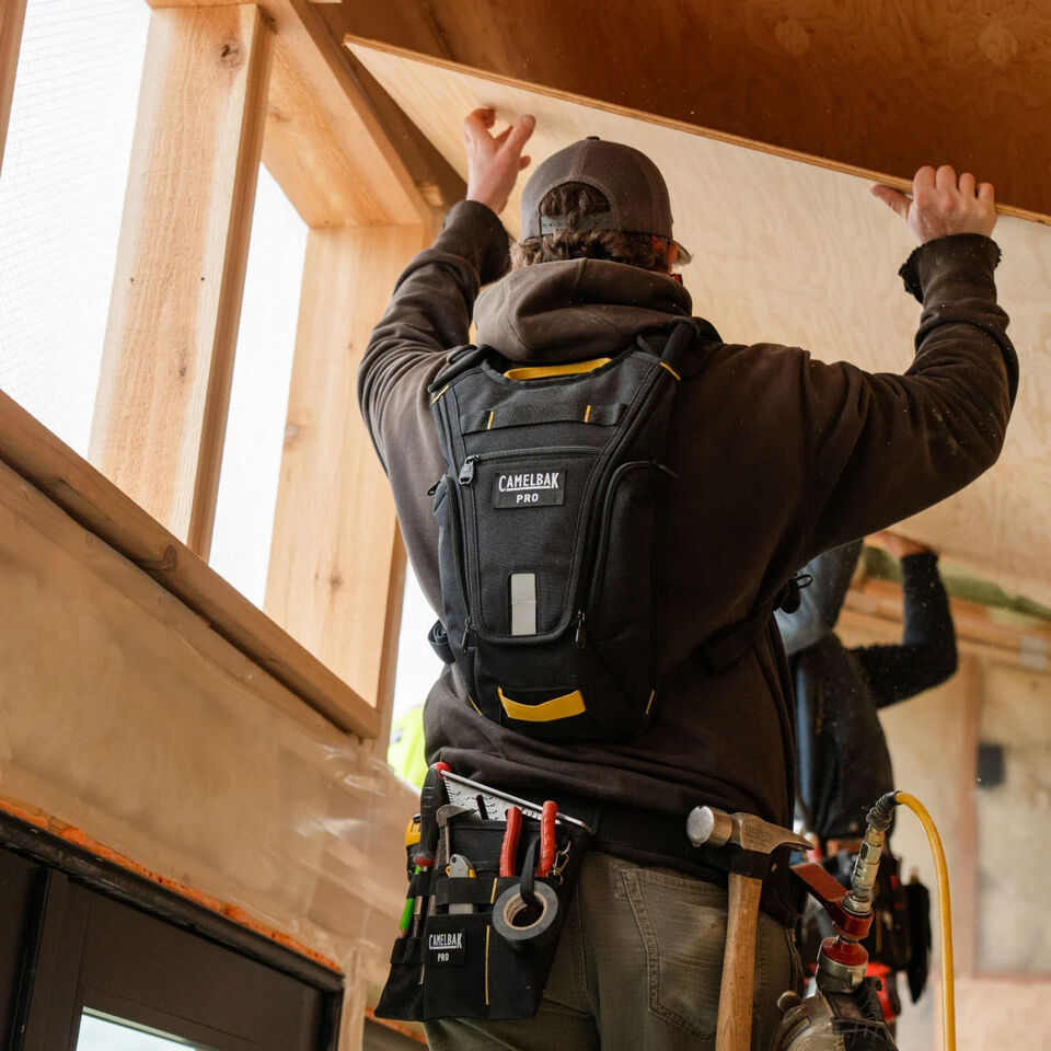 Man working construction with camelbak pro hydration pack