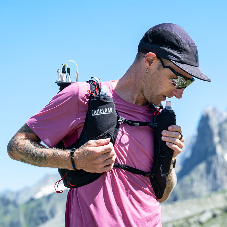 Man drinking water with his Apex run vest Man drinking water with his Apex run vest