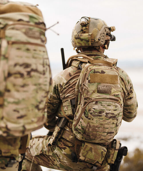 Back of person in Military with pack on