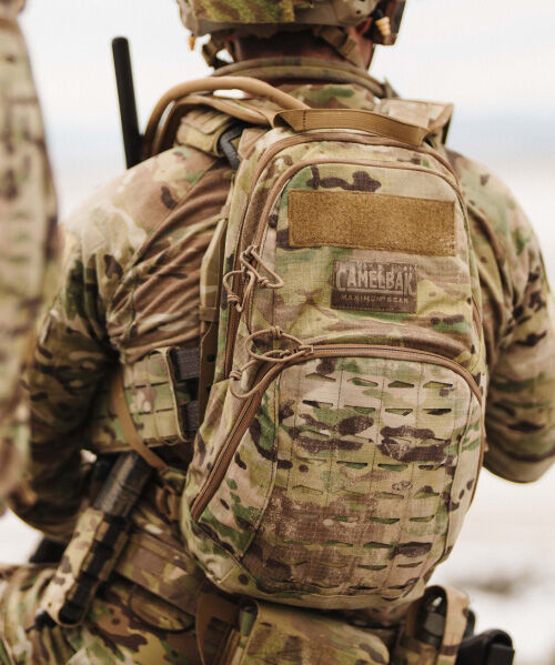 Close up of Tactical pack with beige text "H.A.W.G" behind