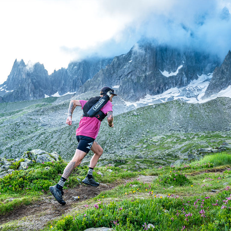 Man running with an Apex running vest Man running with an Apex running vest