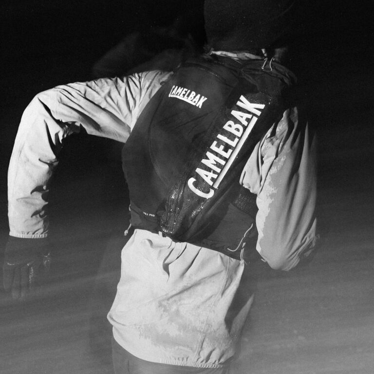 A man running with a camelbak pack