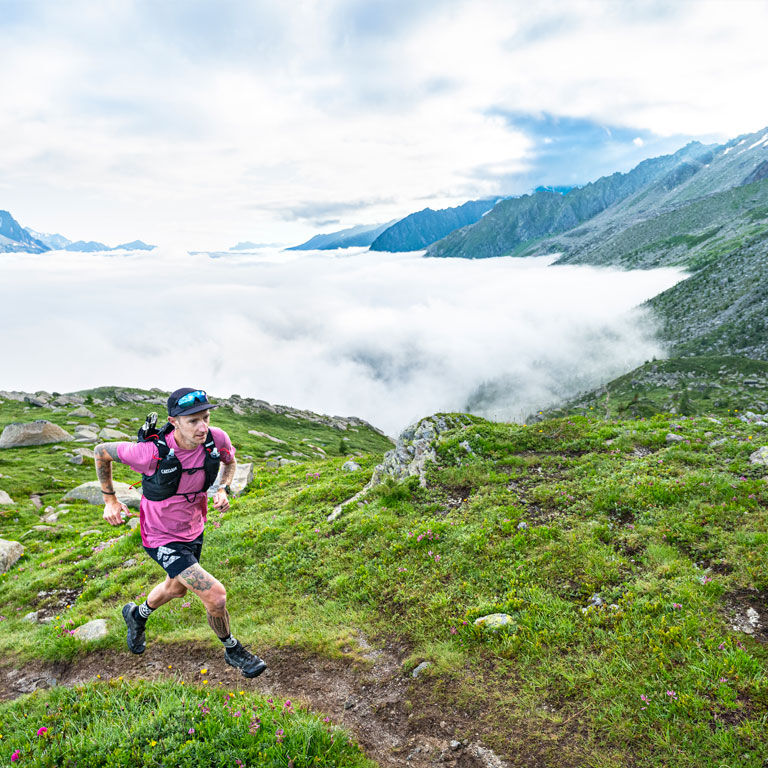 Man running with an Apex running vest Man running with an Apex running vest
