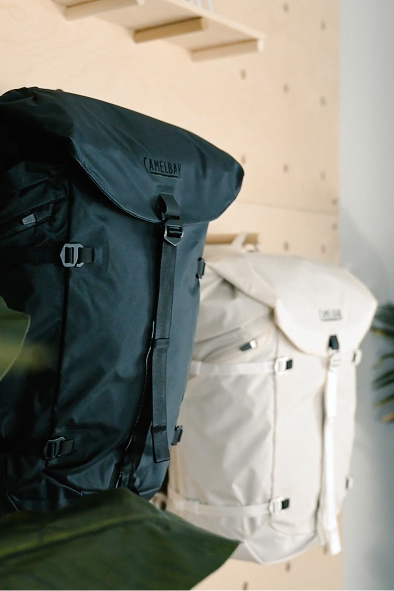 Two ATP backpacks hanging on a display wall.