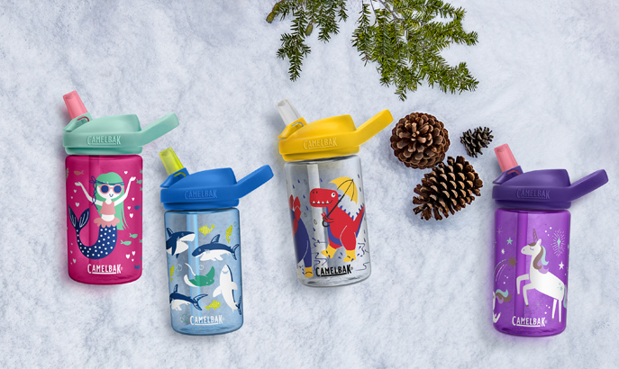 Four kids bottles laying on snow. Four kids bottles laying on snow.