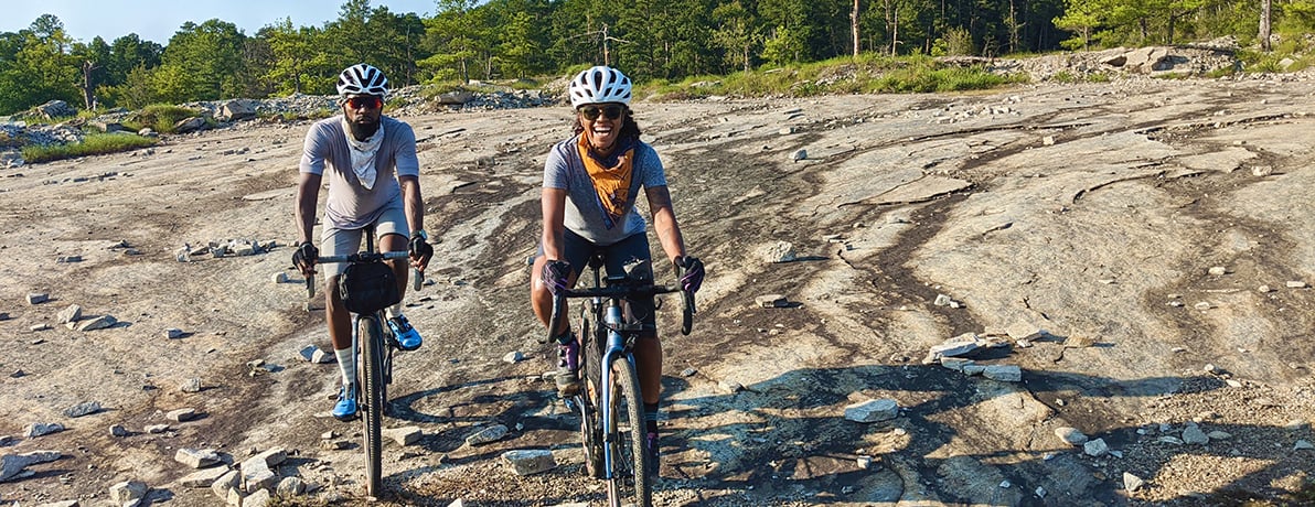 Man and woman riding bikes on the trail. 