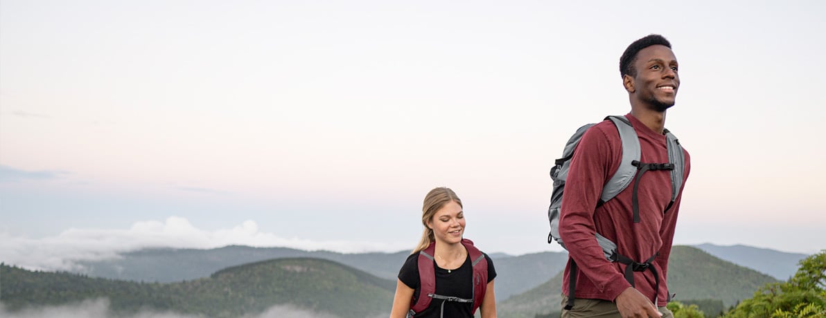 Man and women hiking up a mountain together. 