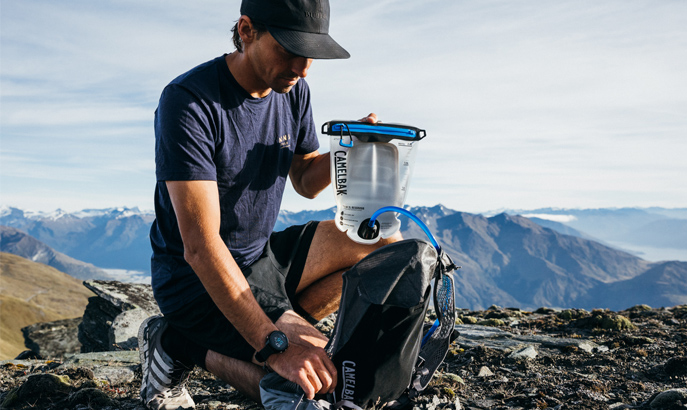 Man filling up a hydration pack using an new LE Fusion Reservoir