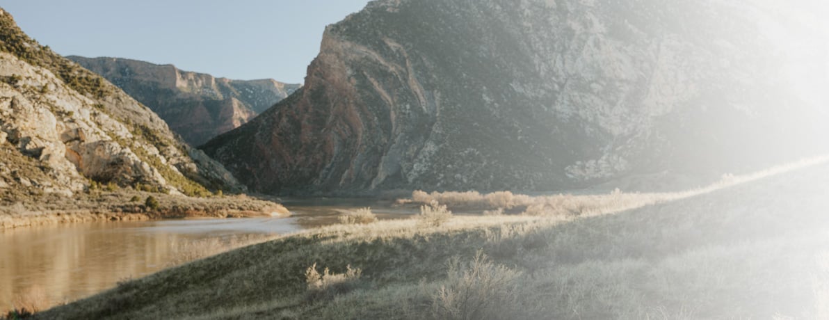 Landscape image of a river running through mountains. 