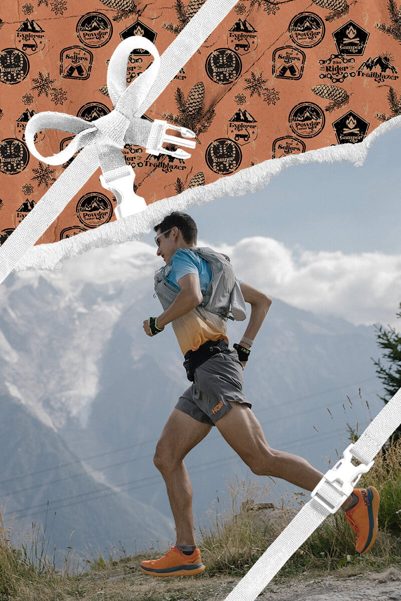 A runner going down a trail with holiday themed wrapping paper framing the area around him. 