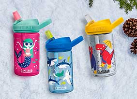Three kids bottles laying on snow background. Three kids bottles laying on snow background.