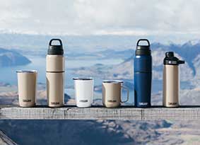 A row of Drinkware lined up on a railing. A row of Drinkware lined up on a railing.