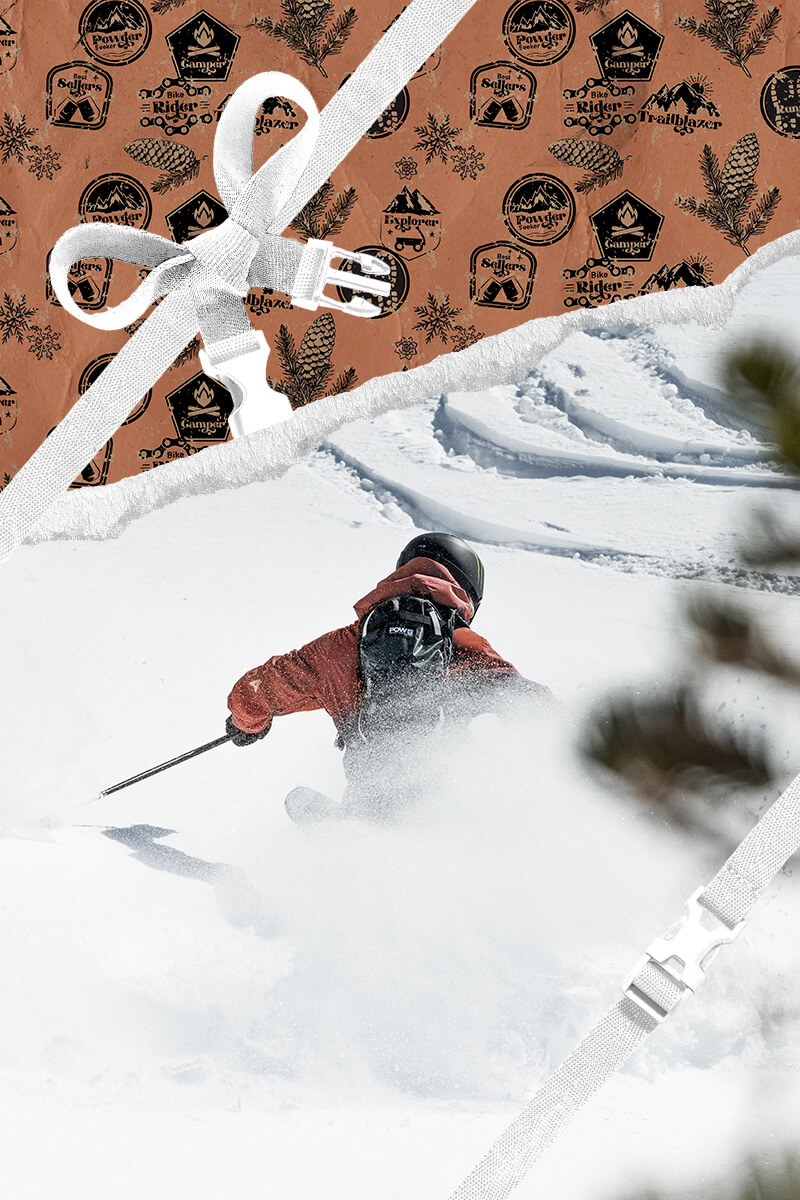 Skier going down a snowy mountain with holiday themed wrapping paper framing the area around her.