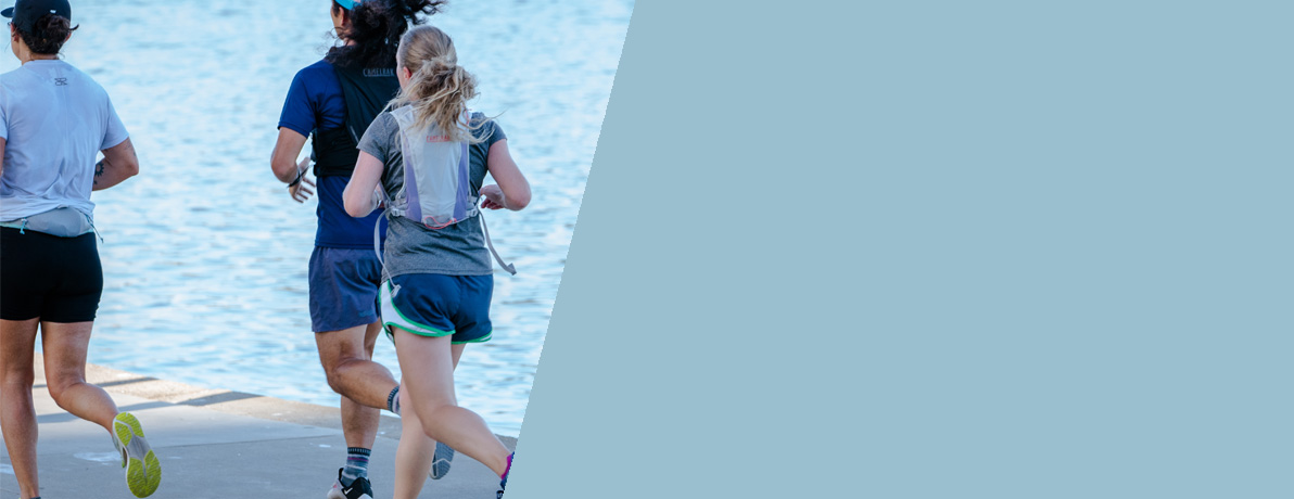 Three runners by a lake