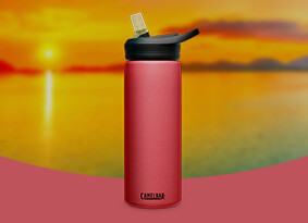 Wild Strawberry Eddy+ bottle with a sunset background