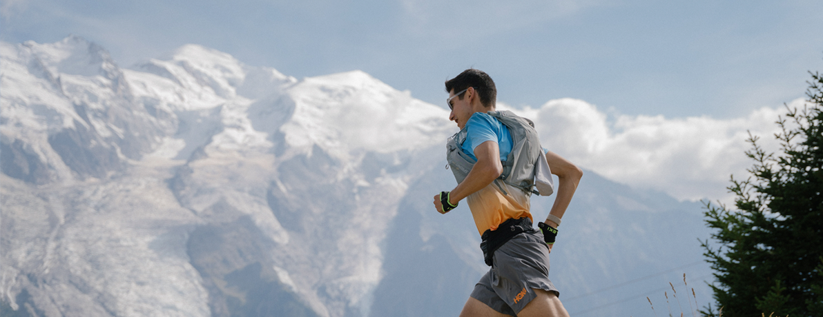 Sage Canaday running through the mountains wearing a Zephyr Pro Vest. 