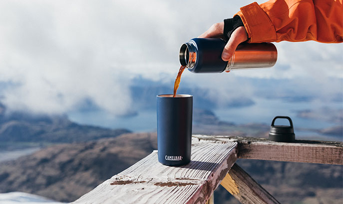 A drink being poured into a Horizon tumbler.