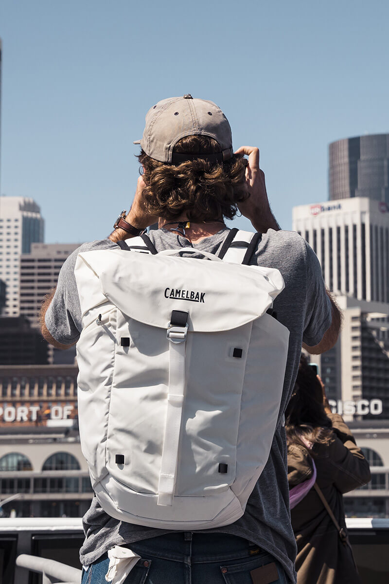 Man overlooking downtown San Francisco with an ATP 26 Backpack on.