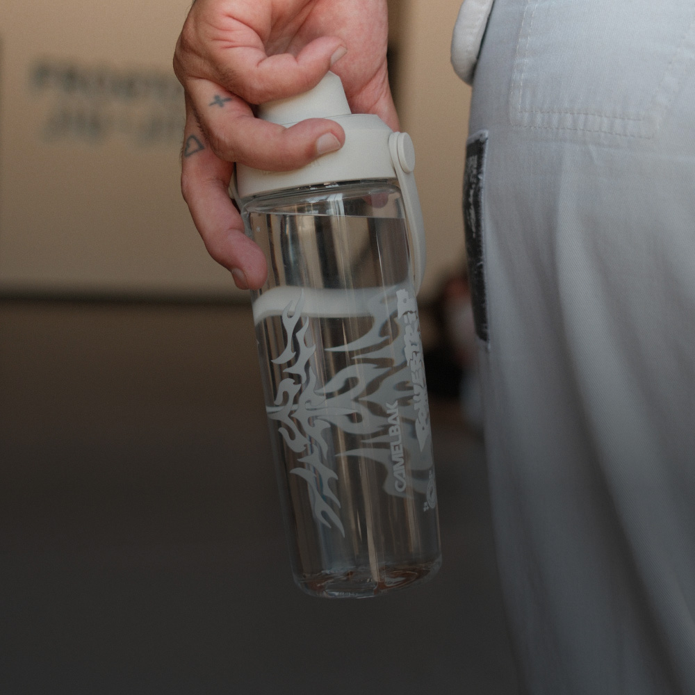 person holding a clear customized bottle with white font